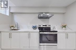 Whitby (Rolling Acres) apartment for rent - A white kitchen with a stove and cabinets.