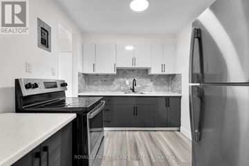 London East (East H) multi-family for rent - A kitchen with a refrigerator on the right side.