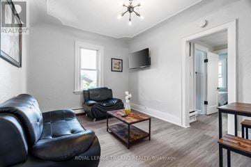 London South (South F) multi-family for rent - A living room with a black leather chair and a wooden coffee table.