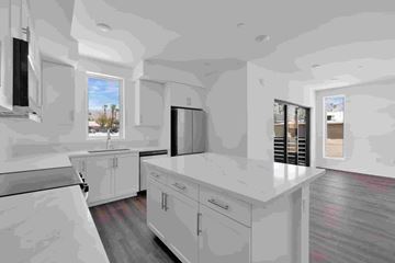 Cathedral City apartment for rent - A kitchen with white cabinets and a large island.