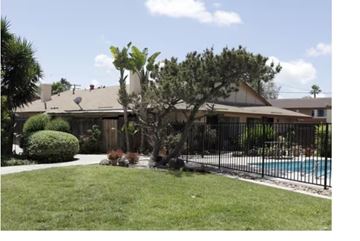 Anaheim apartment for rent - A house with a pool and a tree in front.