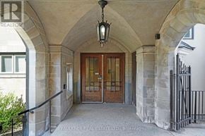 Ottawa condo for rent - A stone archway leads to a wooden door.