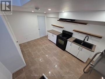 Niagara Falls (Forestview) apartment for rent - A kitchen with white cabinets and a black oven.