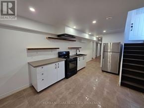 Niagara Falls (Forestview) apartment for rent - A kitchen with white cabinets and a stainless steel refrigerator.