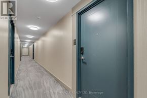 Mississauga (Hurontario) condo for rent - A hallway with a blue door and a carpeted floor.