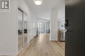 Mississauga (Hurontario) condo for rent - A spacious hallway with wooden floors and white walls.