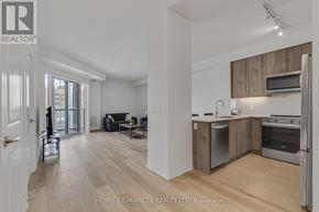 Mississauga (Hurontario) condo for rent - A well-lit, spacious kitchen and living room with wooden floors and modern appliances.
