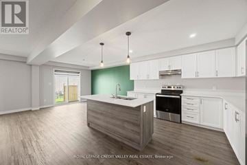 London South (South U) townhouse for rent - A modern kitchen with white cabinets and a wooden island.