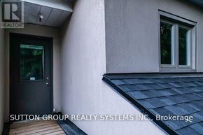 Toronto (High Park-Swansea) apartment for rent - A house with a black door and a window with a white frame.