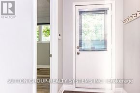 Toronto (High Park-Swansea) apartment for rent - A white door with a window and blinds is shown in a room.