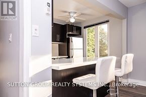 Toronto (High Park-Swansea) apartment for rent - A kitchen with white chairs and a countertop.