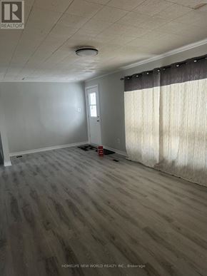 Aurora apartment for rent - A room with a door and a window with curtains.