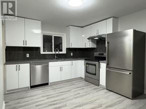 Aurora apartment for rent - A modern kitchen with white cabinets and stainless steel appliances.