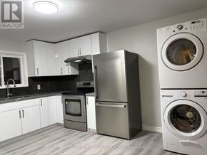 Aurora apartment for rent - A modern kitchen with a washing machine and dryer.