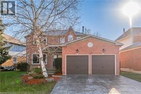 Cambridge apartment for rent - A house with a red brick exterior and a large driveway.