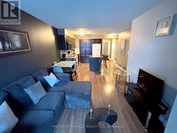 Mississauga (City Centre) condo for rent - A living room with a grey couch and a piano.