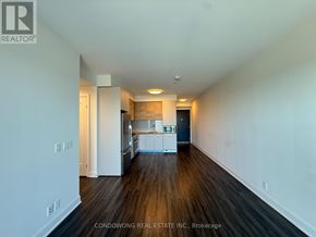 Markham (Commerce Valley) condo for rent - A spacious room with wood flooring and white walls.