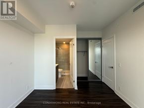Markham (Commerce Valley) condo for rent - A white hallway with a toilet visible in the distance.