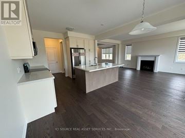 Kitchener apartment for rent - A spacious kitchen with white cabinets and a large island.