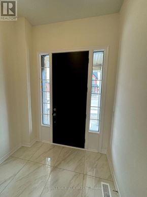 Kitchener apartment for rent - A black door in a room with a tiled floor.