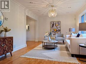 Toronto (Don Valley Village) apartment for rent - A well-lit, spacious living room with a chandelier, a sofa, a coffee table, and a side table.