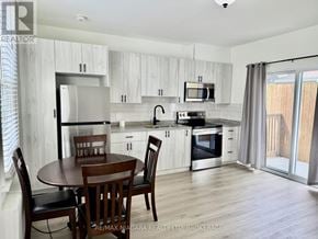 Niagara Falls (Downtown) multi-family for rent - A kitchen with a table and chairs.