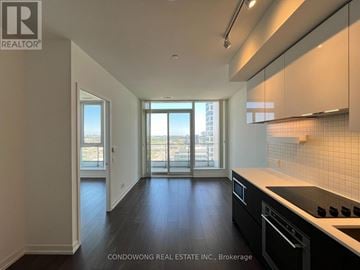 Vaughan (Vaughan Corporate Centre) condo for rent - A kitchen with a stove top oven and a window with a view of the city.