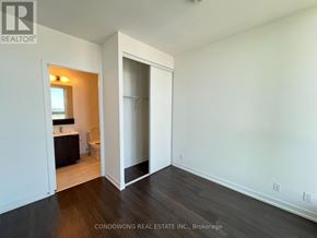 Vaughan (Vaughan Corporate Centre) condo for rent - A room with a white wall and a wooden floor.