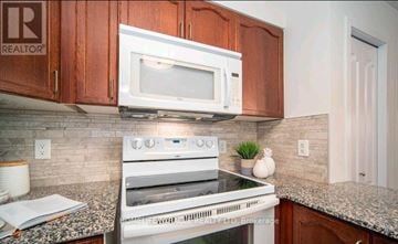 Brampton (Goreway Drive Corridor) condo for rent - A kitchen with a white microwave above a stove.