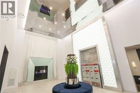 Grimsby condo for rent - A large white room with a fireplace and a vase of flowers on a table.