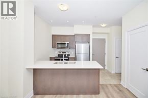 Grimsby condo for rent - A modern kitchen with a white countertop and stainless steel appliances.