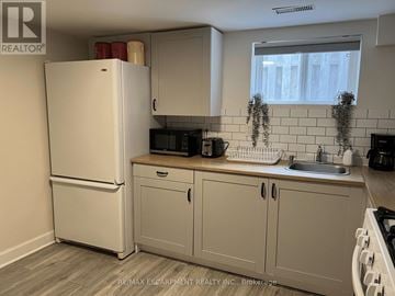 Hamilton (Sunninghill) apartment for rent - A kitchen with a white refrigerator and cabinets.