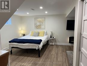 Hamilton (Sunninghill) apartment for rent - A bedroom with a bed, nightstand, and lamp.