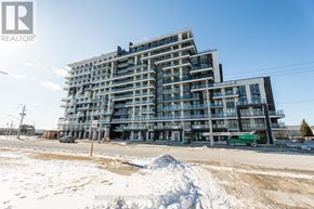 Hamilton (Lakeshore) condo for rent - A large, modern building with many windows is under construction.
