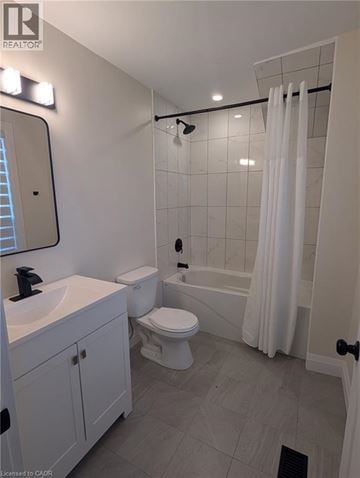 Hamilton apartment for rent - A white bathroom with a toilet, sink, and shower.