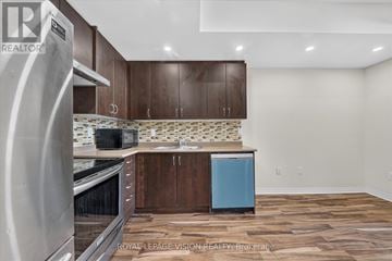 Toronto (Malvern) townhouse for rent - A kitchen with wooden cabinets and a blue dishwasher.