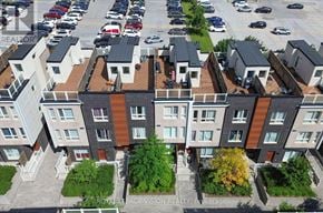 Toronto (Malvern) townhouse for rent - A bird's eye view of a residential area with apartment buildings and parked cars.