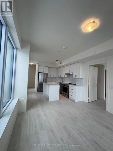 Vaughan (Vellore Village) condo for rent - A spacious kitchen with white cabinets and a large island.