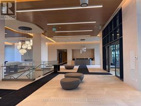 Vaughan (Vellore Village) condo for rent - A modern office lobby with a glass railing and a black and white rug.