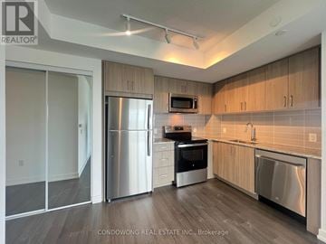 Toronto (Humber Heights) condo for rent - A kitchen with a refrigerator, microwave, and oven.