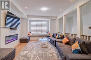 Oakville (Jm Joshua Meadows) townhouse for rent - A living room with a grey couch and a coffee table.