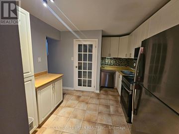 Mississauga (Streetsville) townhouse for rent - A kitchen with white cabinets and a tiled floor.