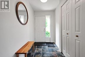Ottawa townhouse for rent - A hallway with a white door and a wooden bench.