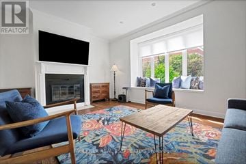 Ottawa townhouse for rent - A living room with a fireplace and a television mounted above it.
