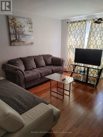Oshawa (Lakeview) apartment for rent - A living room with a grey couch and a painting on the wall.