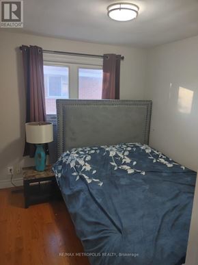 Oshawa (Lakeview) apartment for rent - A bedroom with a bed, nightstand and lamp.