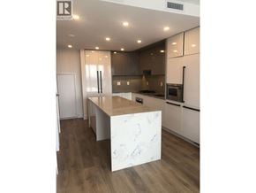 Burnaby apartment for rent - A modern kitchen with a marble island in the middle.