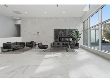 Surrey apartment for rent - A living room with a grey sofa set and a marble floor.