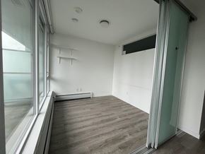 Surrey apartment for rent - A room with a sliding glass door and a grey floor.