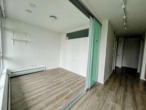Surrey apartment for rent - A room with a wooden floor and a green door.